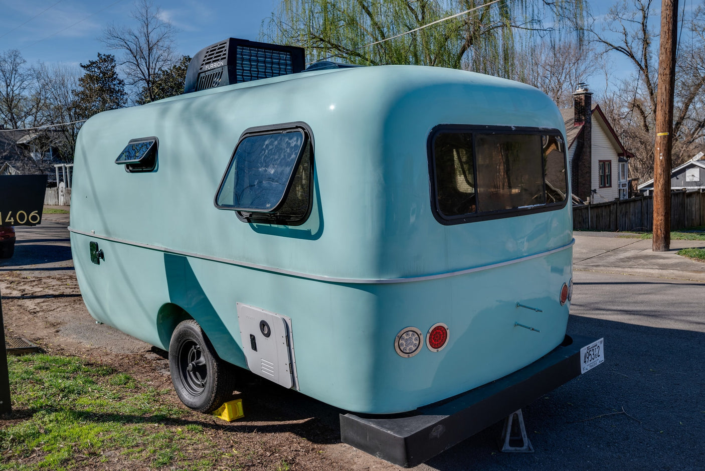 Charming light blue, vintage-style RV rental with modern AC, ideal for travel.
