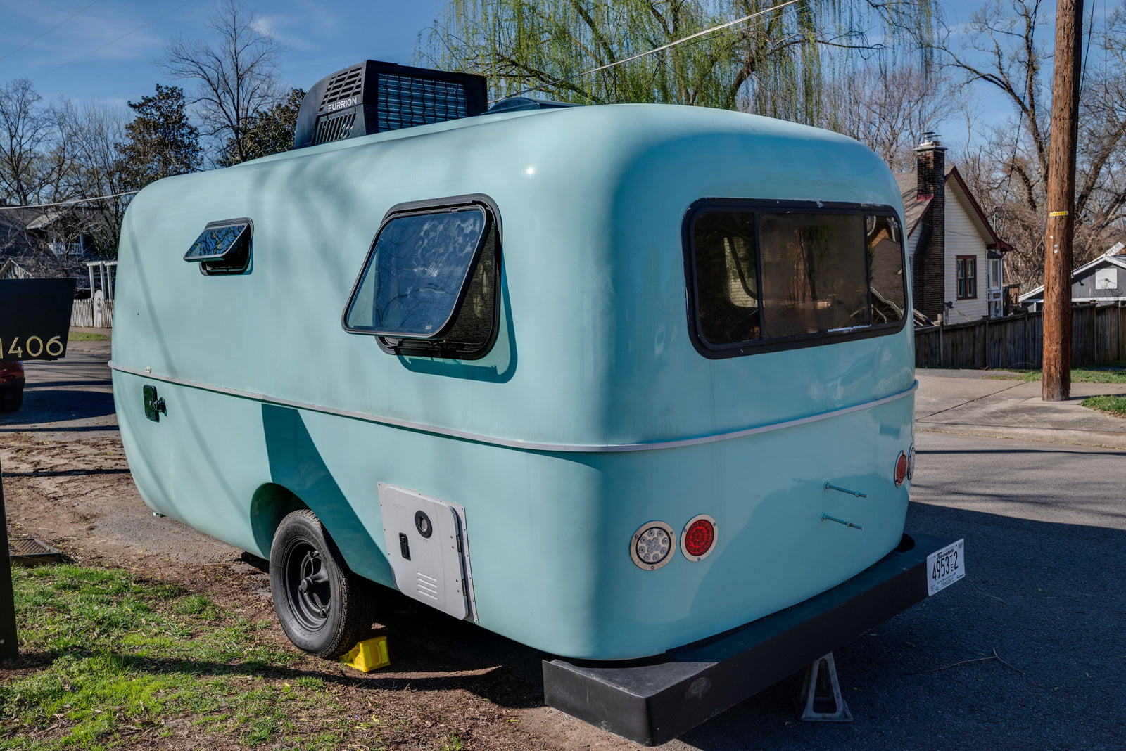 Charming light blue, vintage-style RV rental with modern AC, ideal for travel.