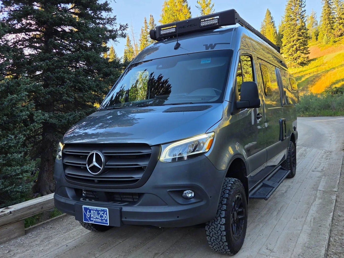 dog nearby. Perfect for outdoor adventure.|Gray Mercedes Sprinter rv rental with off-road tires & roof light bar — photo 5