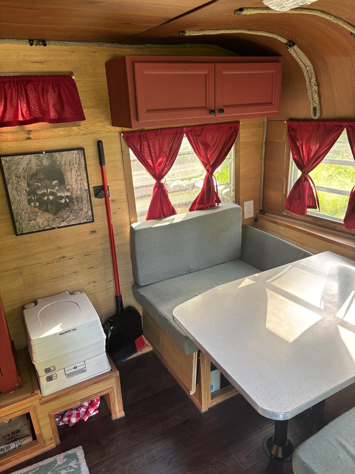 and built-in storage cabinets.|Cozy RV rental bedroom with wood paneling — photo 7