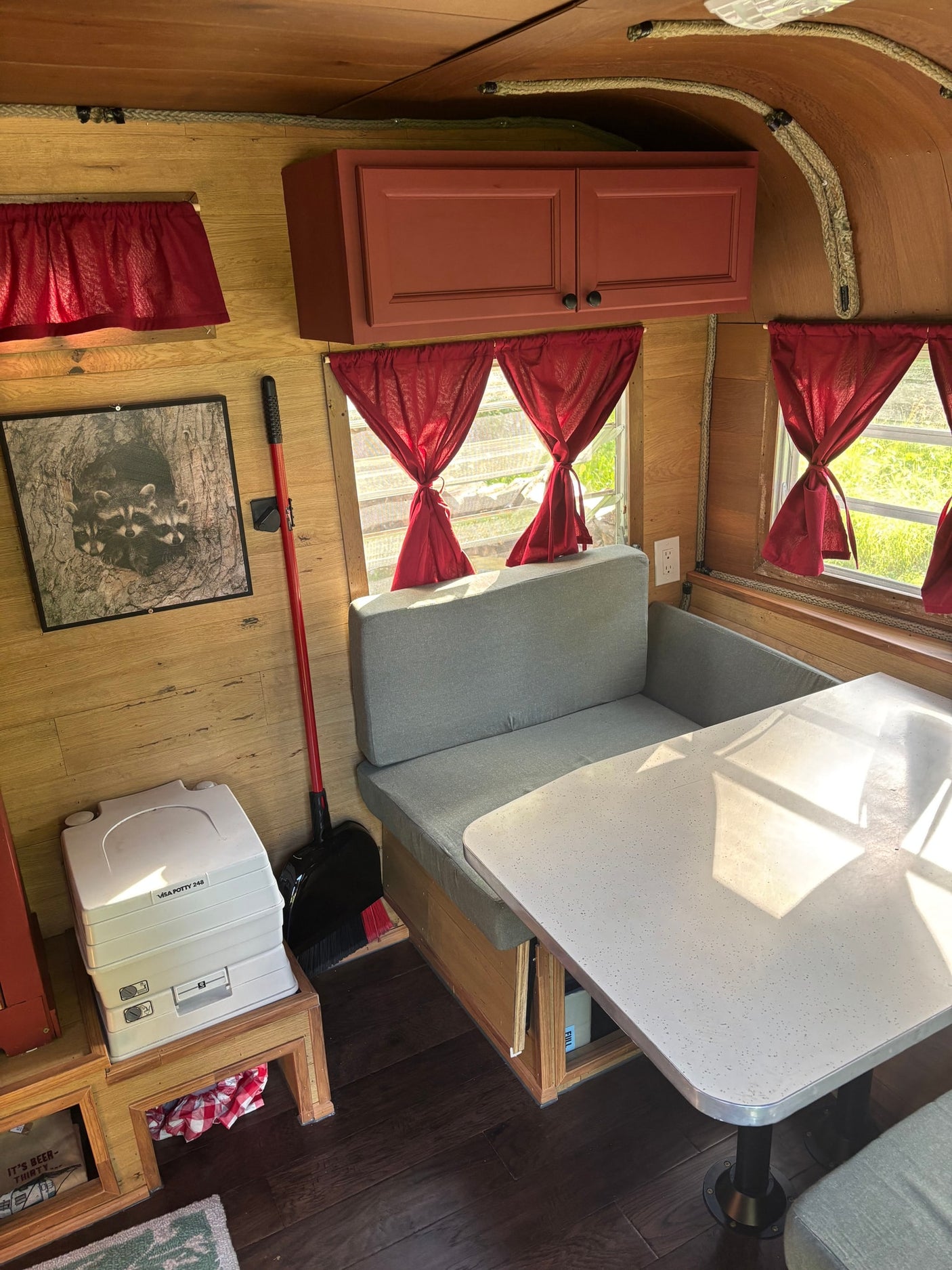 and built-in storage cabinets.|Cozy RV rental bedroom with wood paneling
