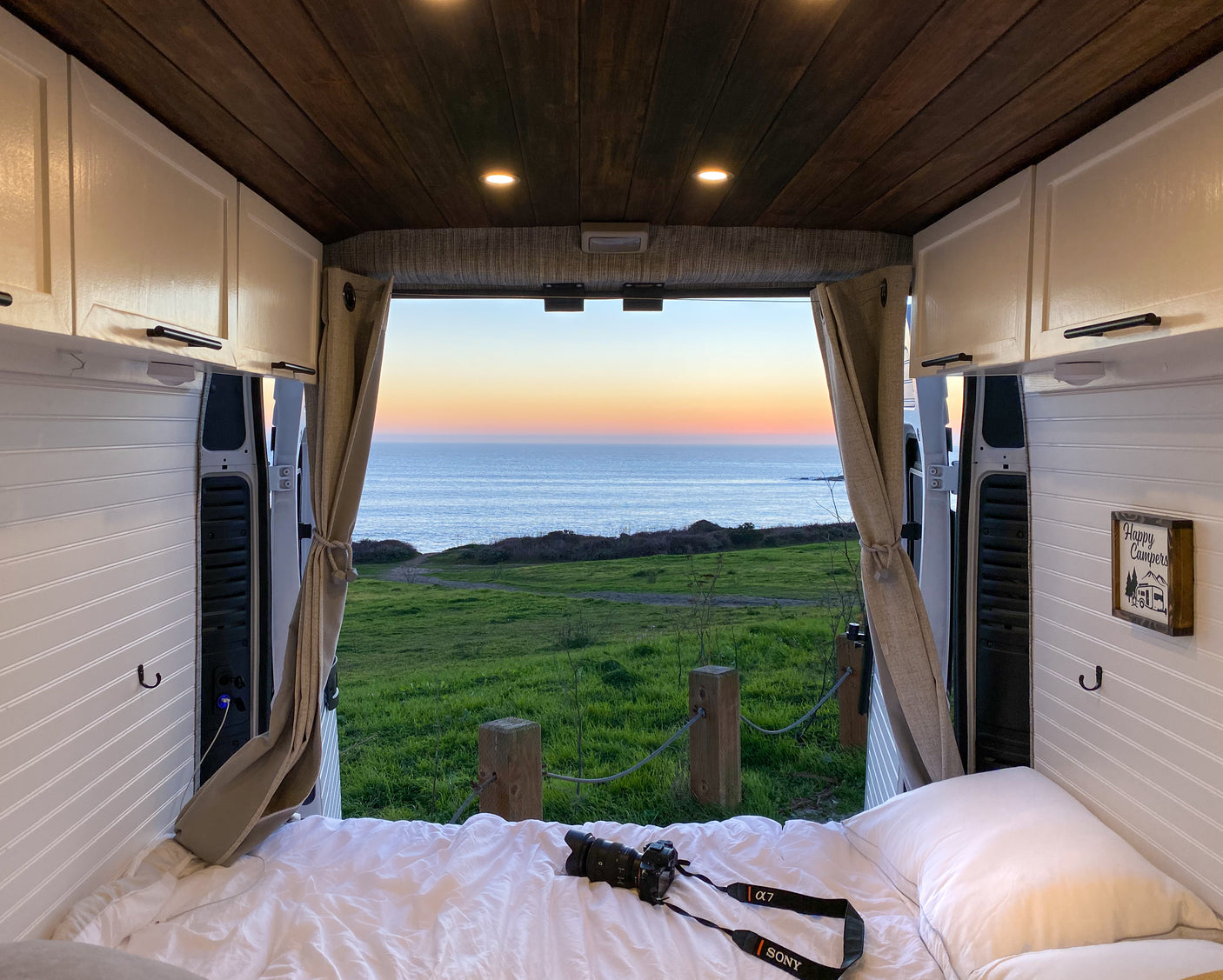 Wake up to amazing coastal views from this cozy rv rental. Perfect for van life, this camper features a comfy bed & ocean sunsets.