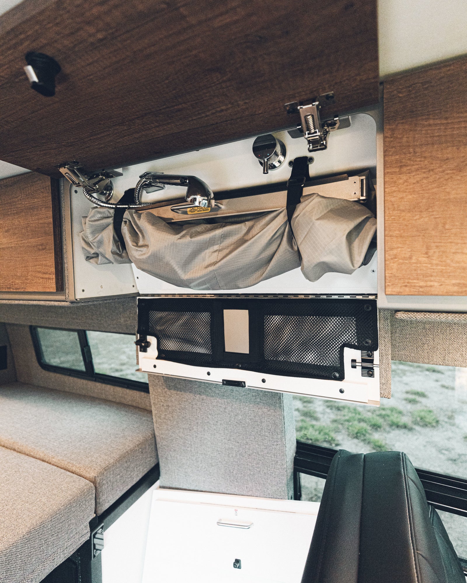 and overhead storage for comfortable travels.|View of an RV rental interior: comfortable bed