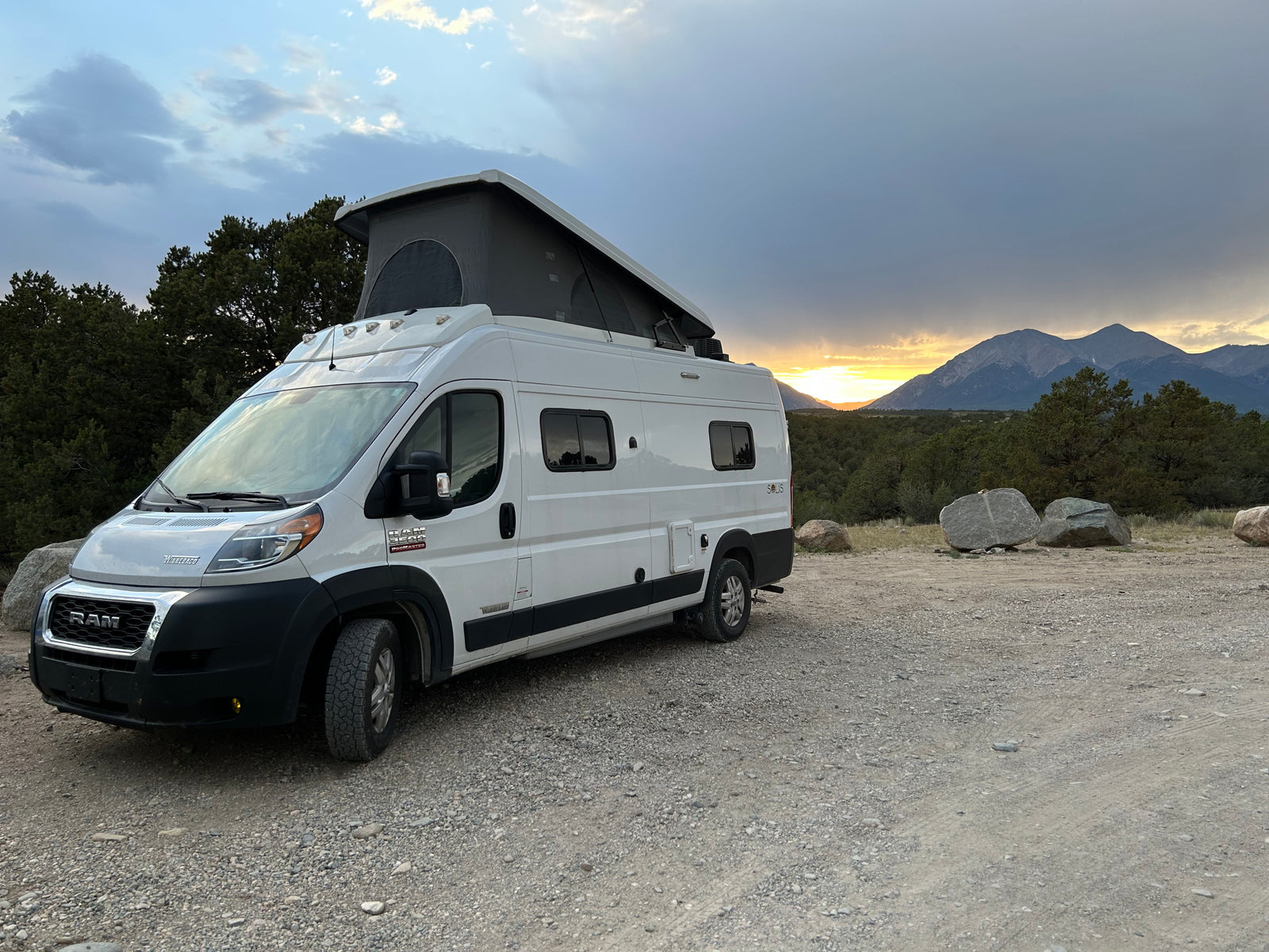 White pop-top RV rental on gravel