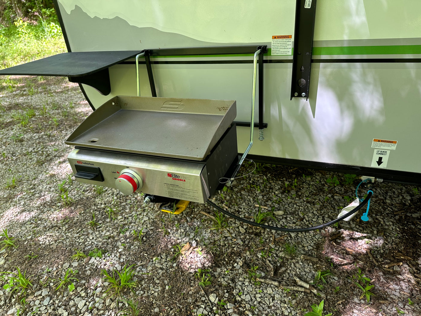 This RV rental features a convenient side-mounted griddle, ideal for outdoor cooking and camping.