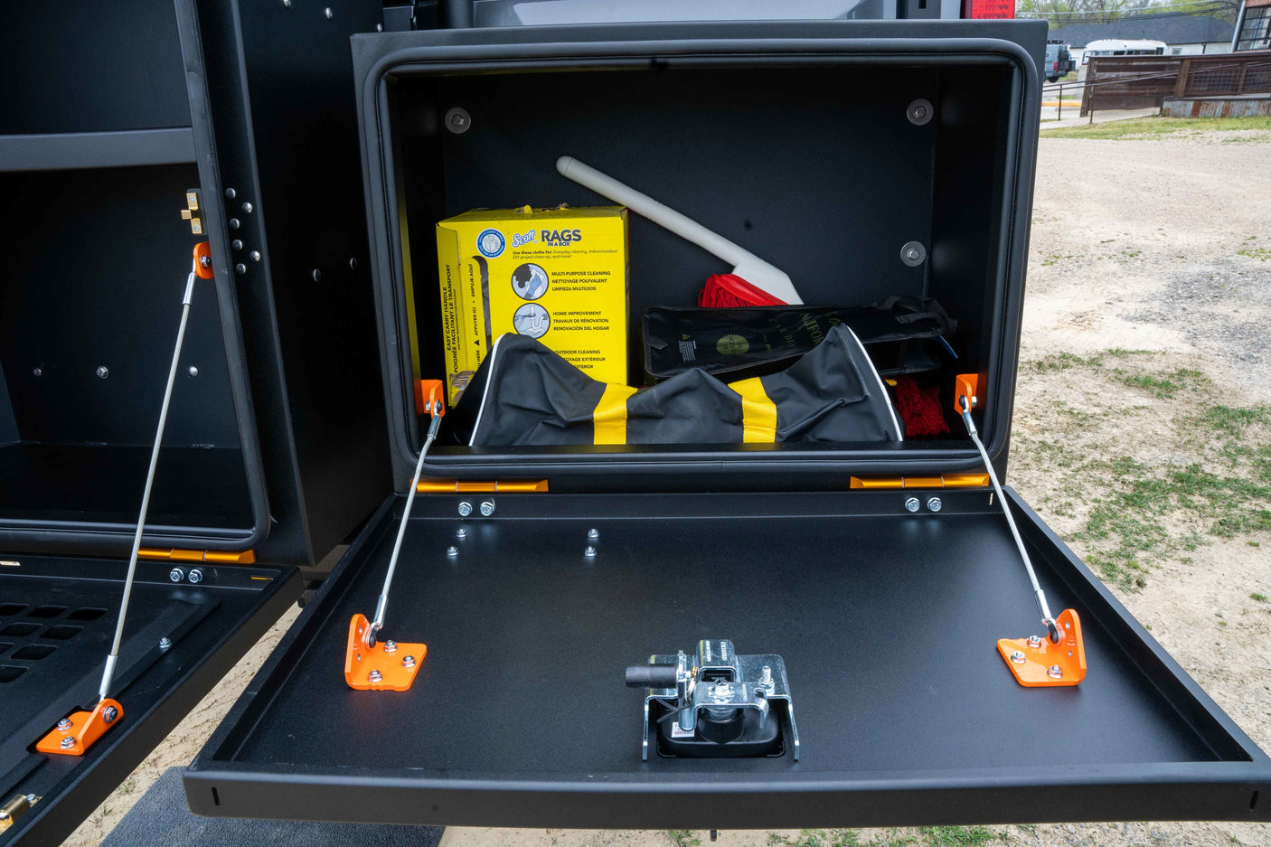 This rv rental features a convenient drop-down utility box, equipped with Scott rags and cleaning supplies for easy access.