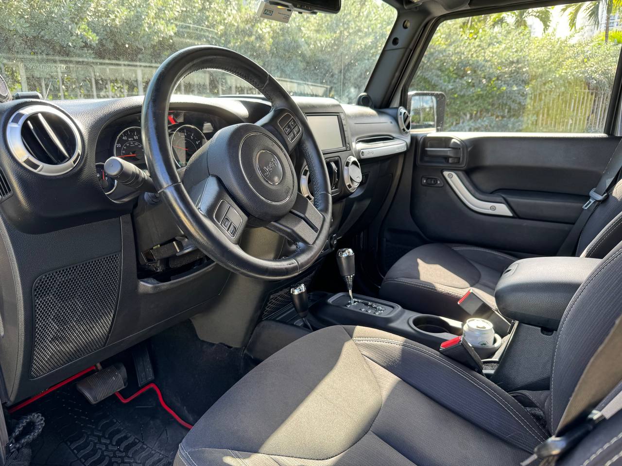 Clean Jeep interior with automatic shifter and black seats, great for your next rv rental adventure. — photo 17