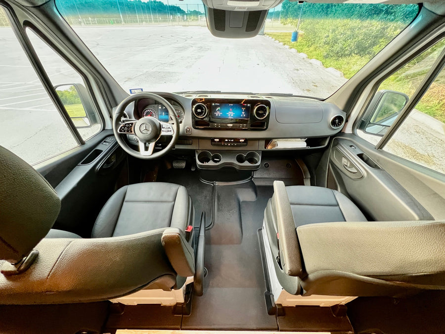 parked in a lot at golden hour.|RV rental: The spacious interior of a modern camper van