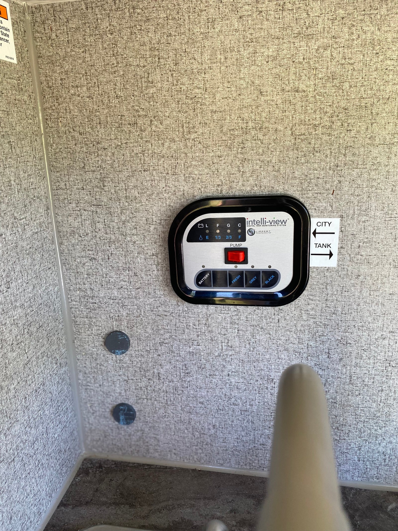 Control panel inside an RV rental: an Intelli-view digital tank monitoring system for battery and water levels.