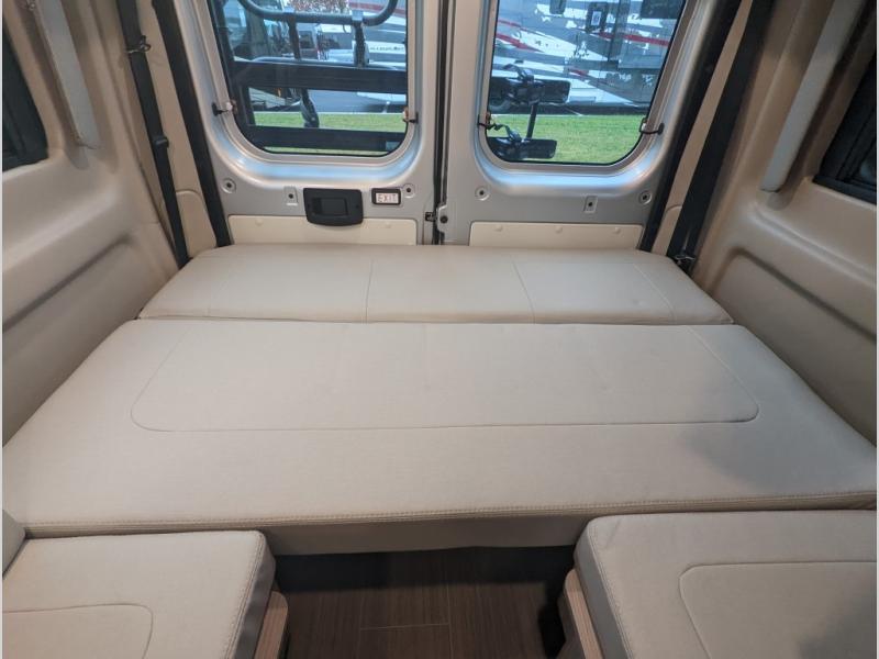 and a pop-top roof.|Bright camper van pop-top tent in an RV rental
