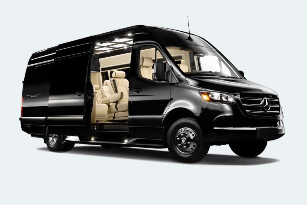 Black luxury Mercedes-Benz Sprinter RV rental van with open side door showing cream interior.|Discover this new black Mercedes-Benz Sprinter van