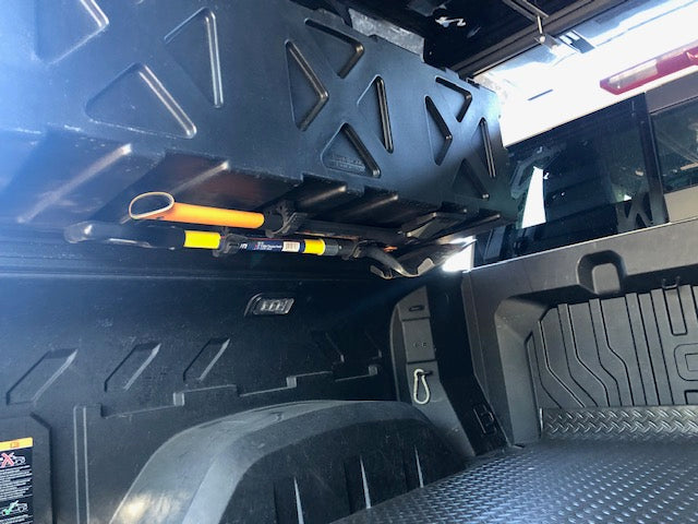 Inside a truck bed: organized storage with a hatchet & other tools, ideal for an RV rental trip.
