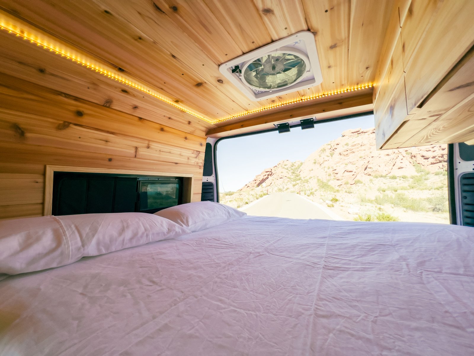 showcasing a custom wood interior. Ready for your next road trip adventure.|Experience comfort in this custom RV rental campervan with a beautiful wood interior