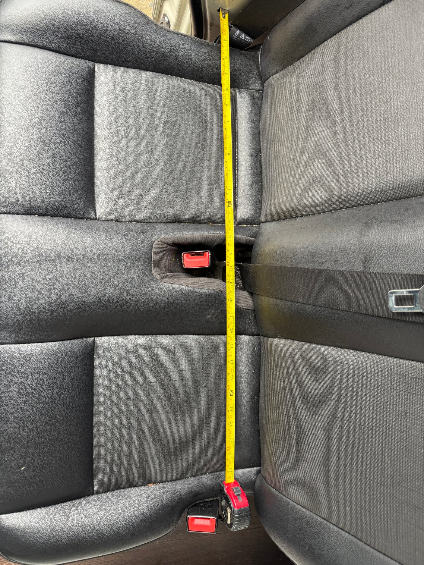 Measuring vehicle rear seat length (approx. 29+ inches) for an RV rental. Provides key dimensions for space planning.