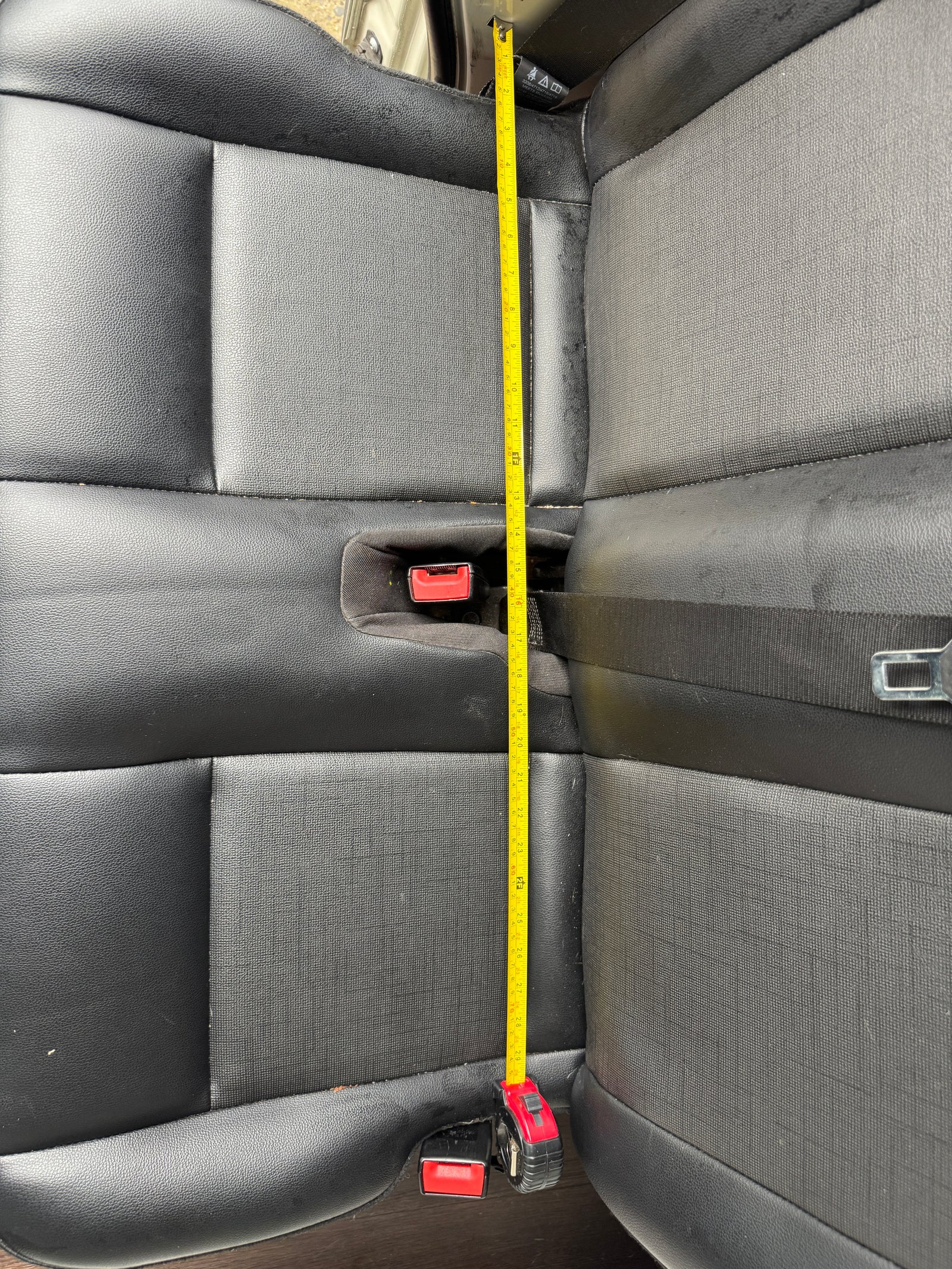 Measuring vehicle rear seat length (approx. 29+ inches) for an RV rental. Provides key dimensions for space planning.