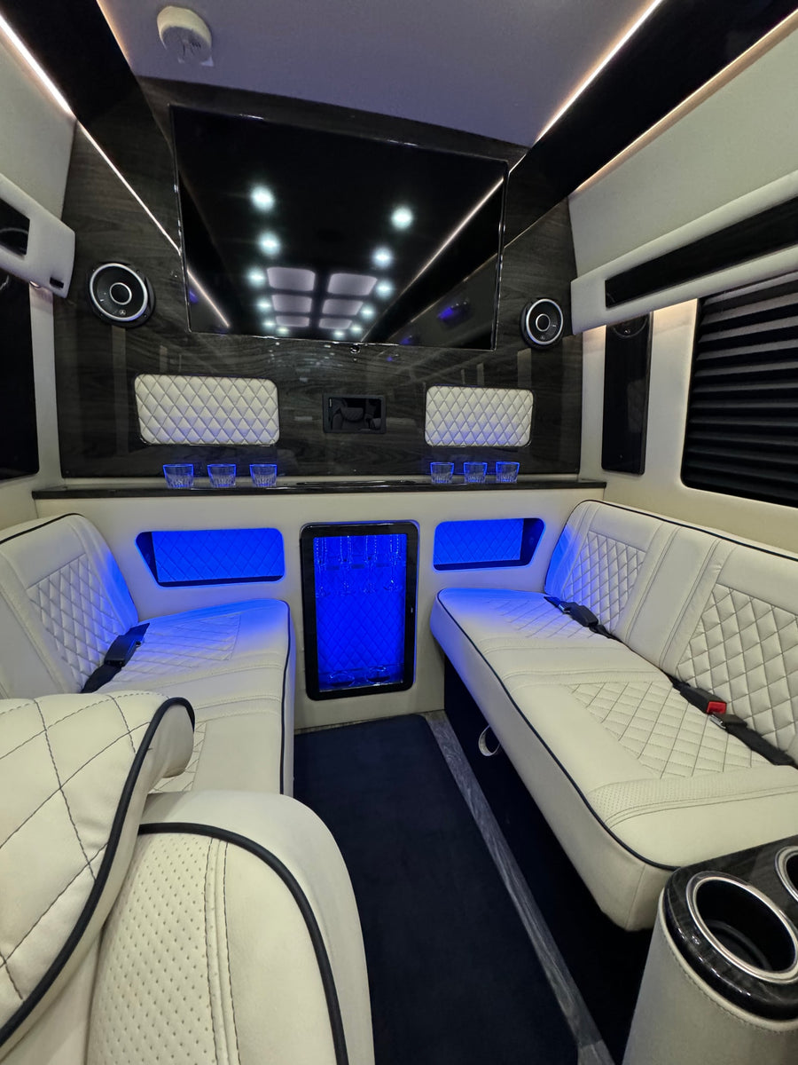 light-colored seating.|Premium RV rental interior with cream quilted captain's chairs