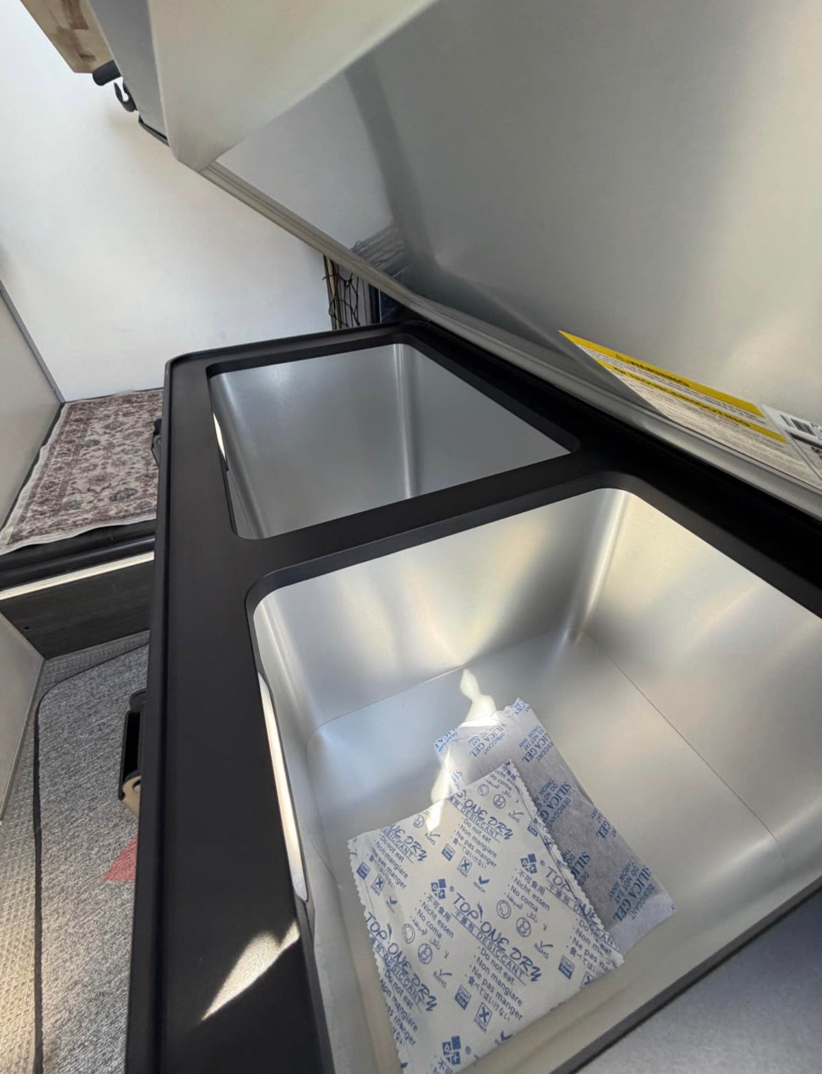 and overhead net.|Compact rv rental interior featuring a Dometic cooktop — photo 7