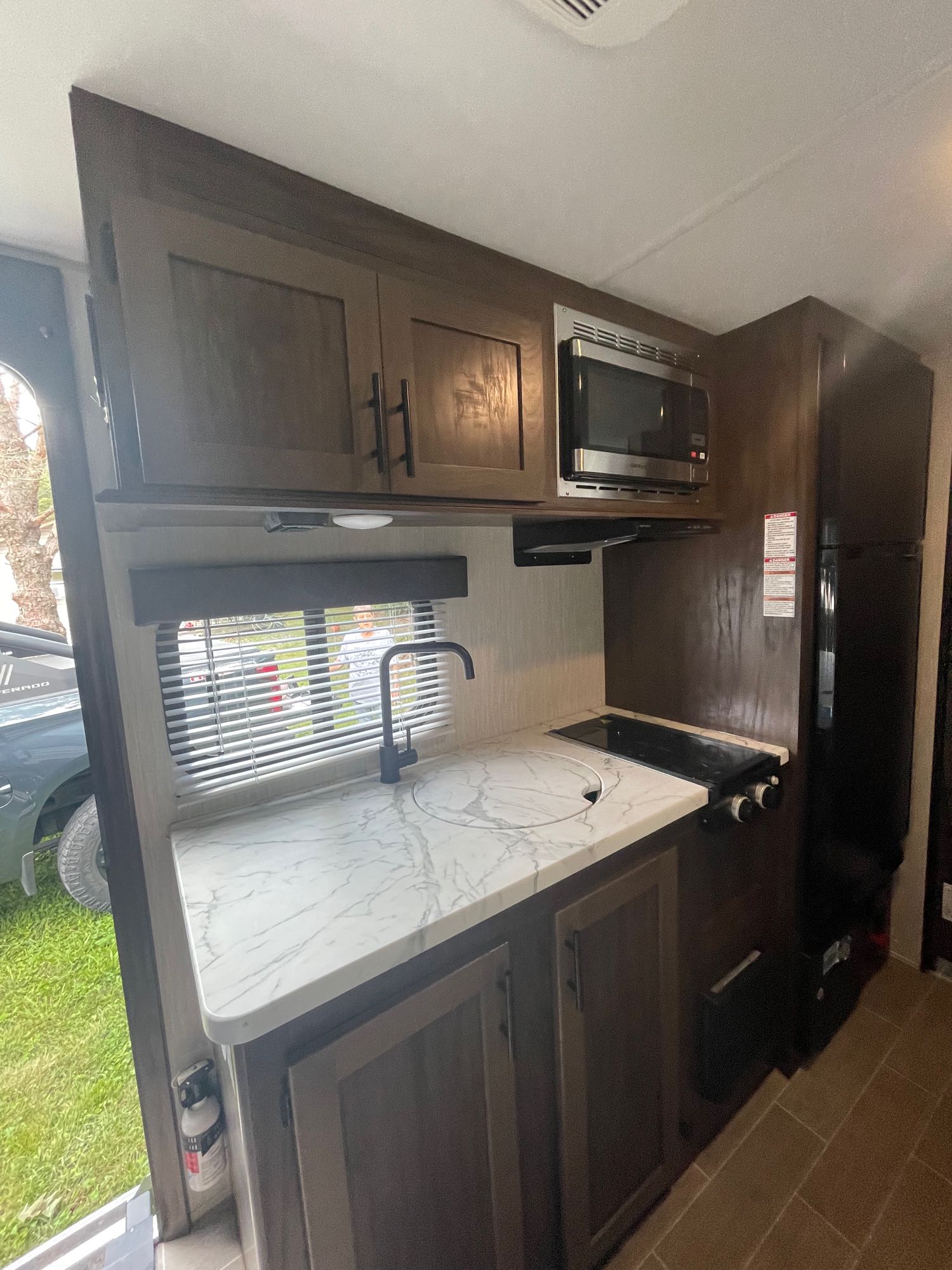 and an accessible outdoor fridge. Perfect for camping and leisure.|A gray & blue Wolf Pup travel trailer
