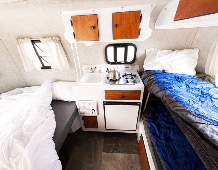 offers a perfect outdoor adventure getaway.|Dark gray Subaru Outback SUV towing a white Scamp travel trailer
