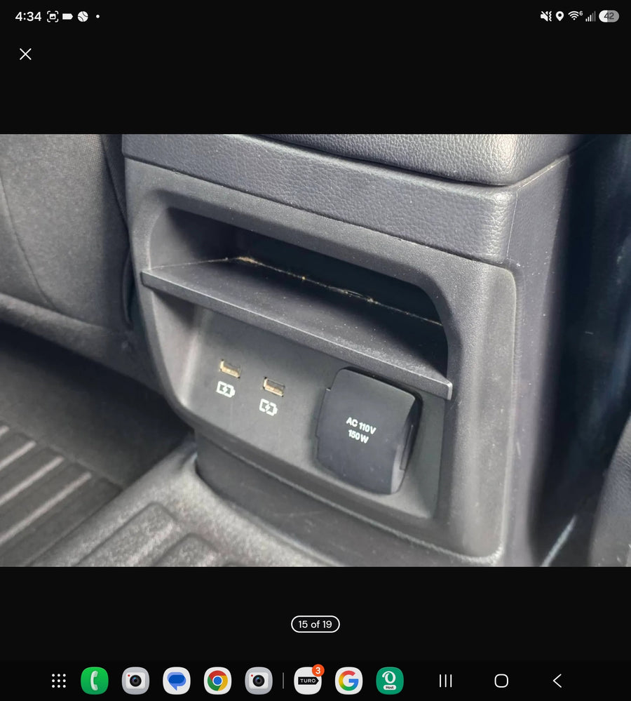 Rear console of an RV rental with USB ports and an AC 110V 150W power outlet, great for charging devices on trips.