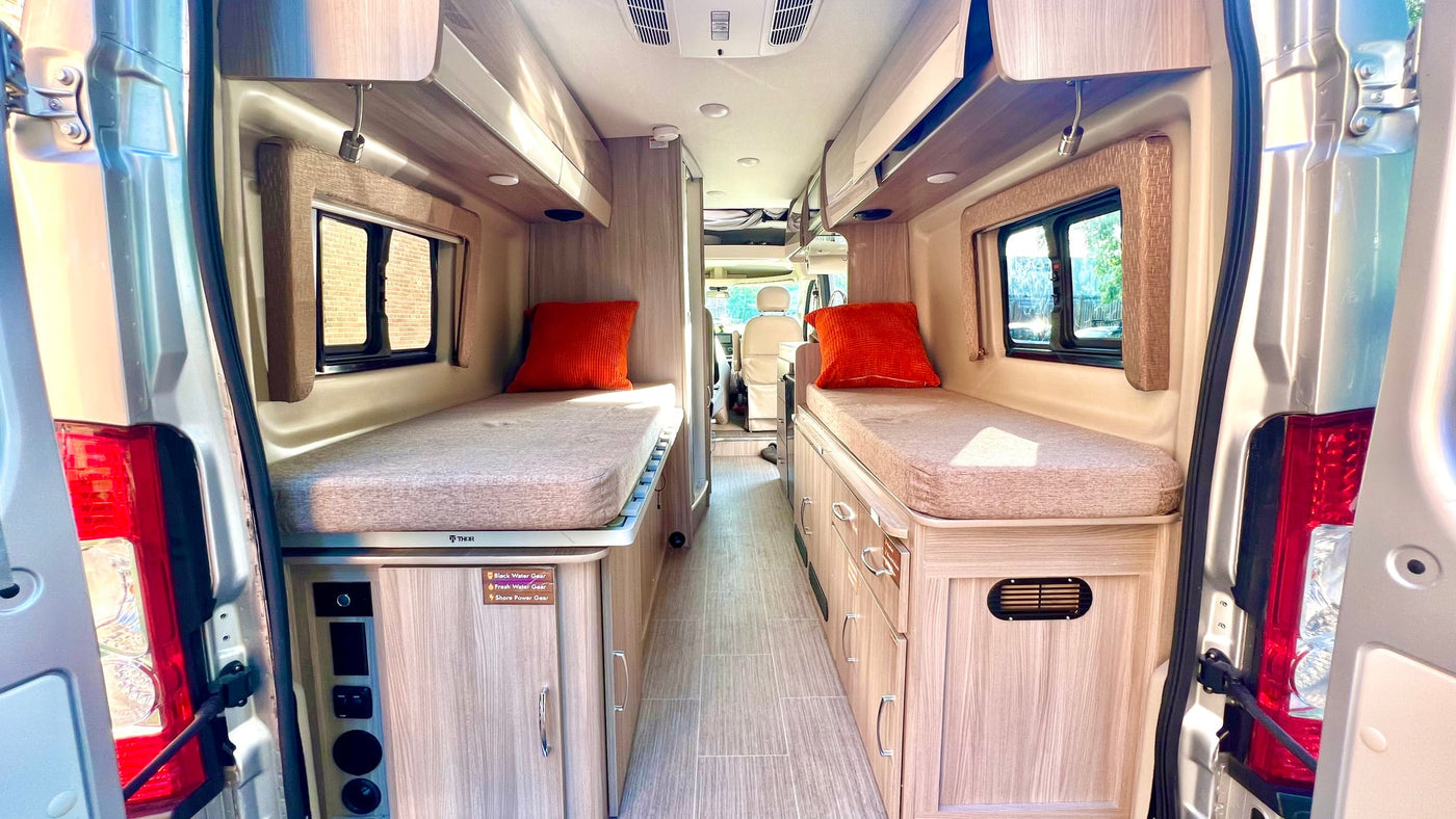 parked in nature.|Warm RV rental interior showing kitchenette — photo 10