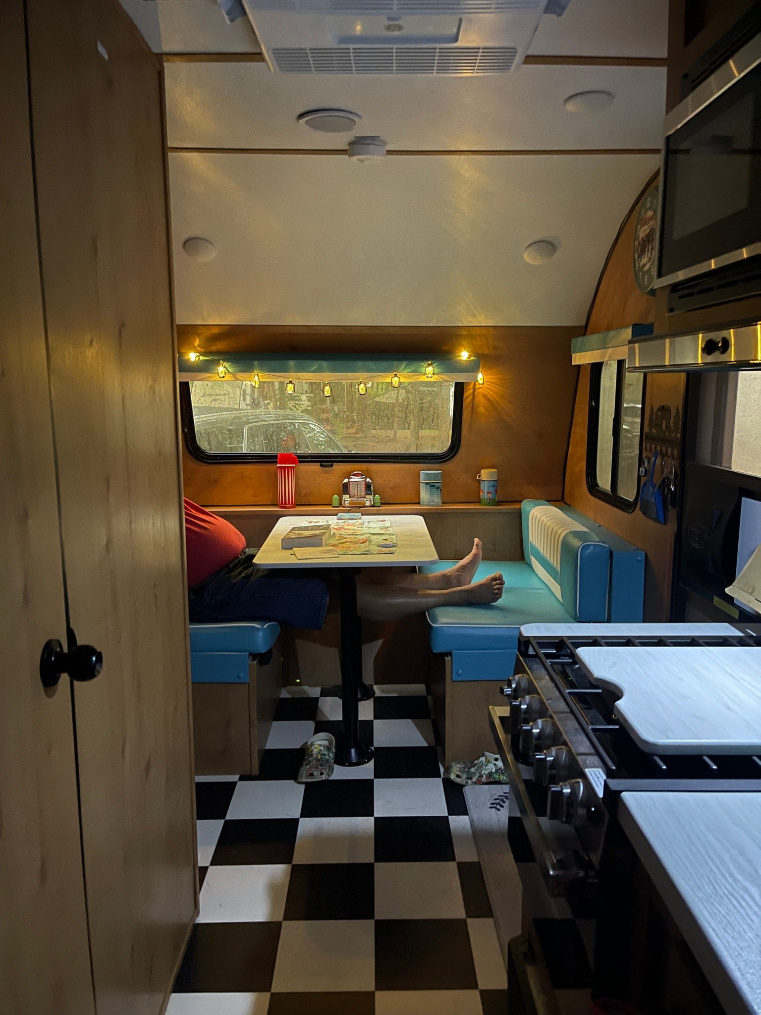 with bright awning lights and a patterned picnic table ready for use.|Man smiles