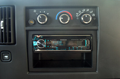 RV rental dashboard: Kenwood car stereo (USB), HVAC controls, air vent, and storage.