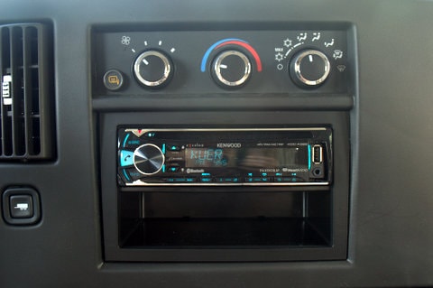 RV rental dashboard: Kenwood car stereo (USB), HVAC controls, air vent, and storage. — photo 3