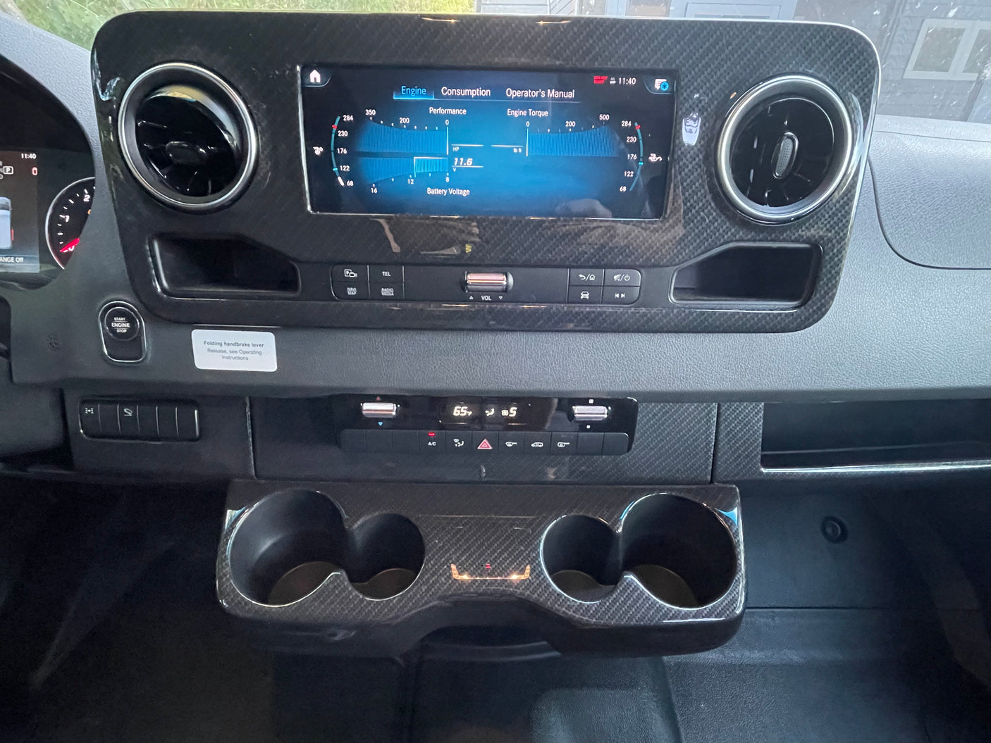 Modern **rv rental** dashboard with central display screen showing engine performance, climate controls, and cup holders.