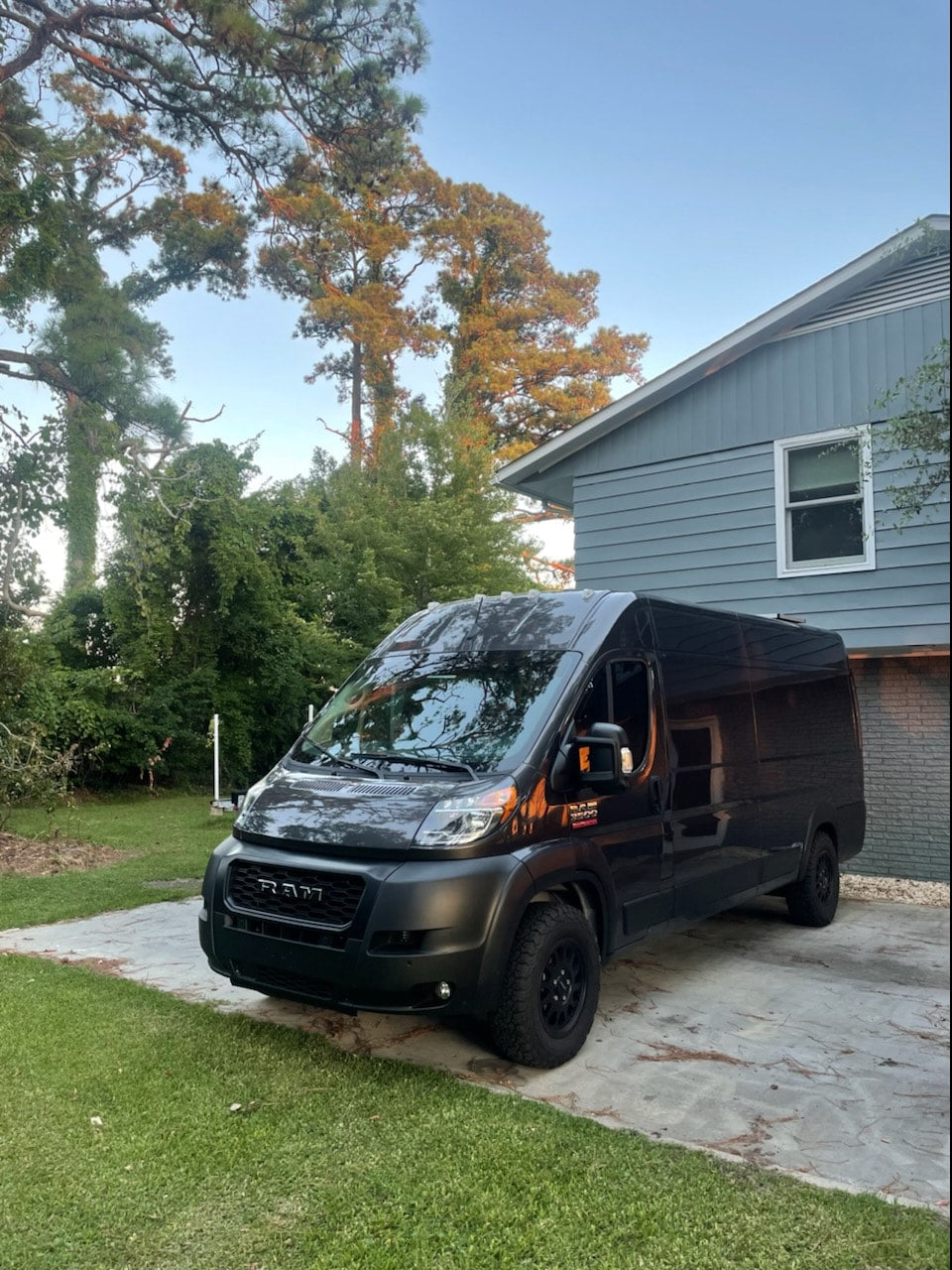ideal for van life adventures.|A happy woman pets her black Lab