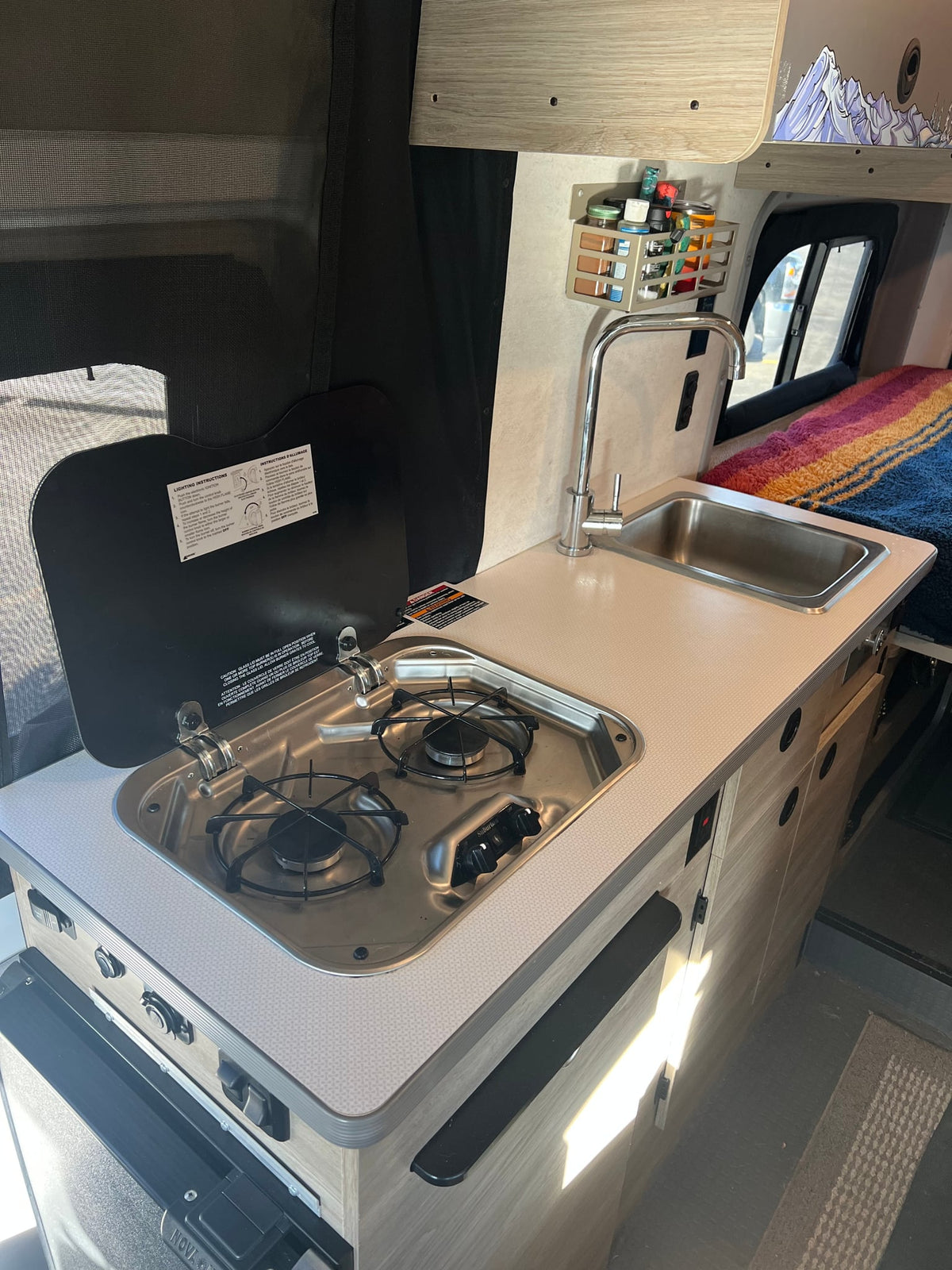 with dark front cabin seats visible.|Spacious RV rental camper van interior: light seats — photo 12