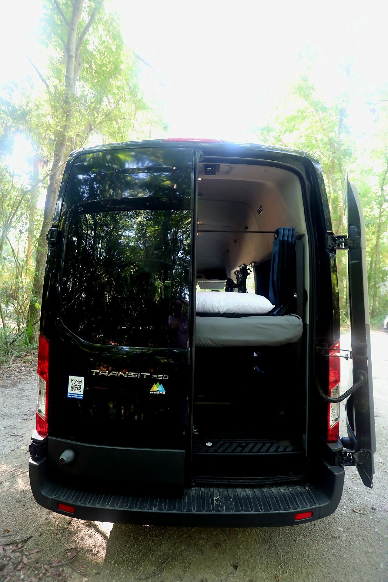 parked in nature.|Family-ready RV rental interior: shows a compact kitchen counter