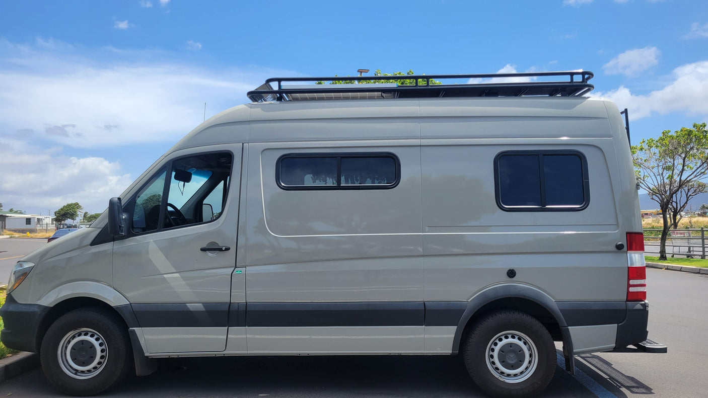 Grey Mercedes Sprinter van RV rental, fitted with solar panels & roof rack, ready for your next adventure.