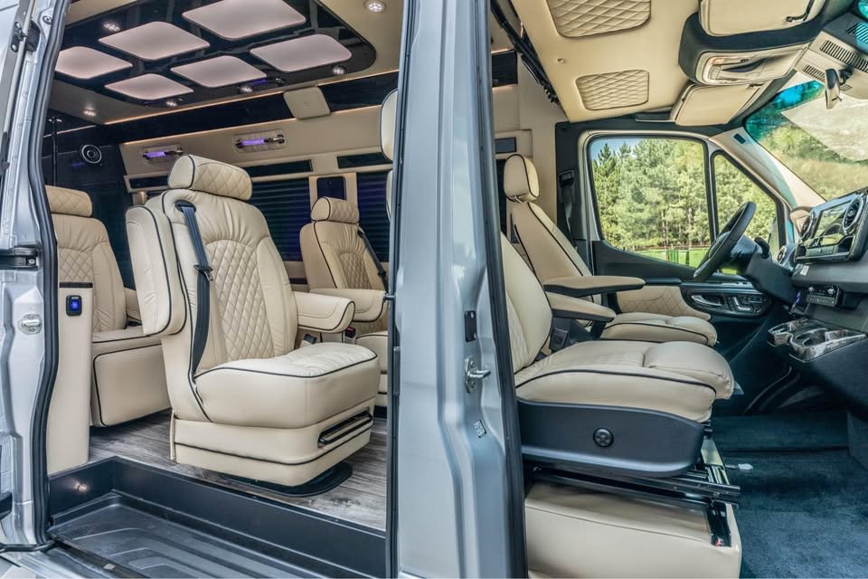 Luxurious rv rental interior with cream leather captain's chairs