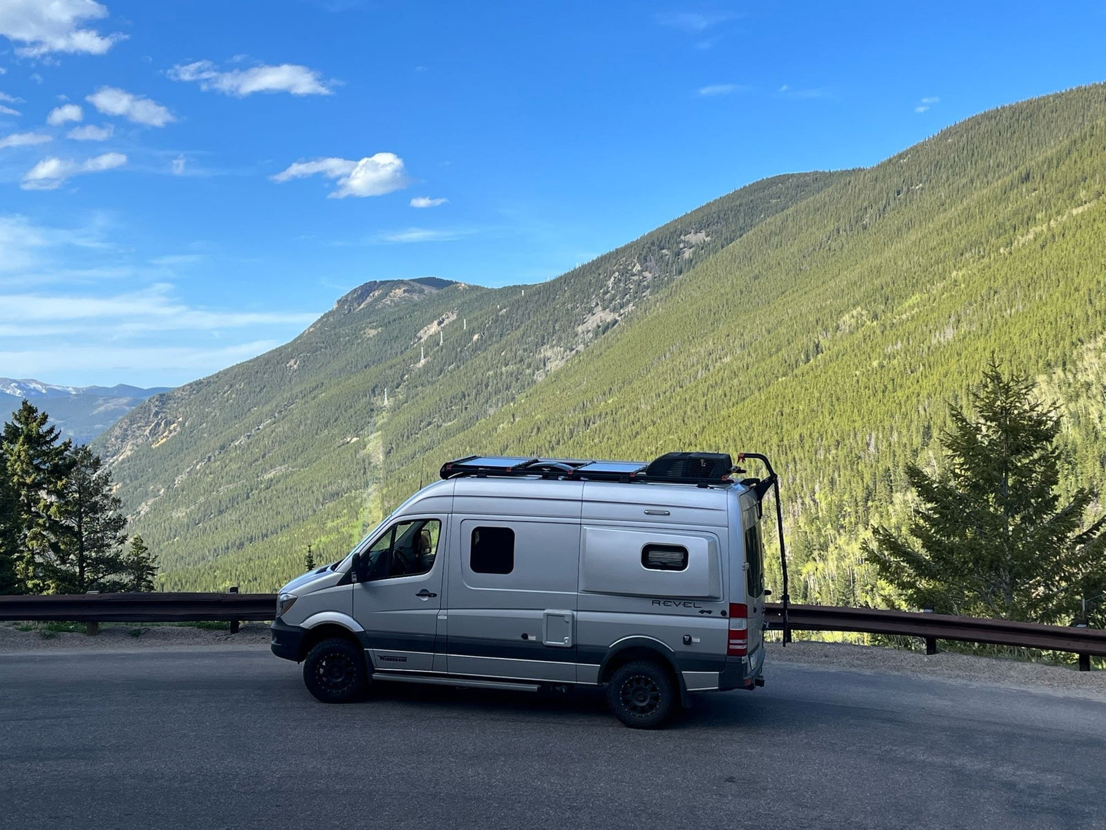 Silver Winnebago Revel 4x4 RV rental on a mountain road