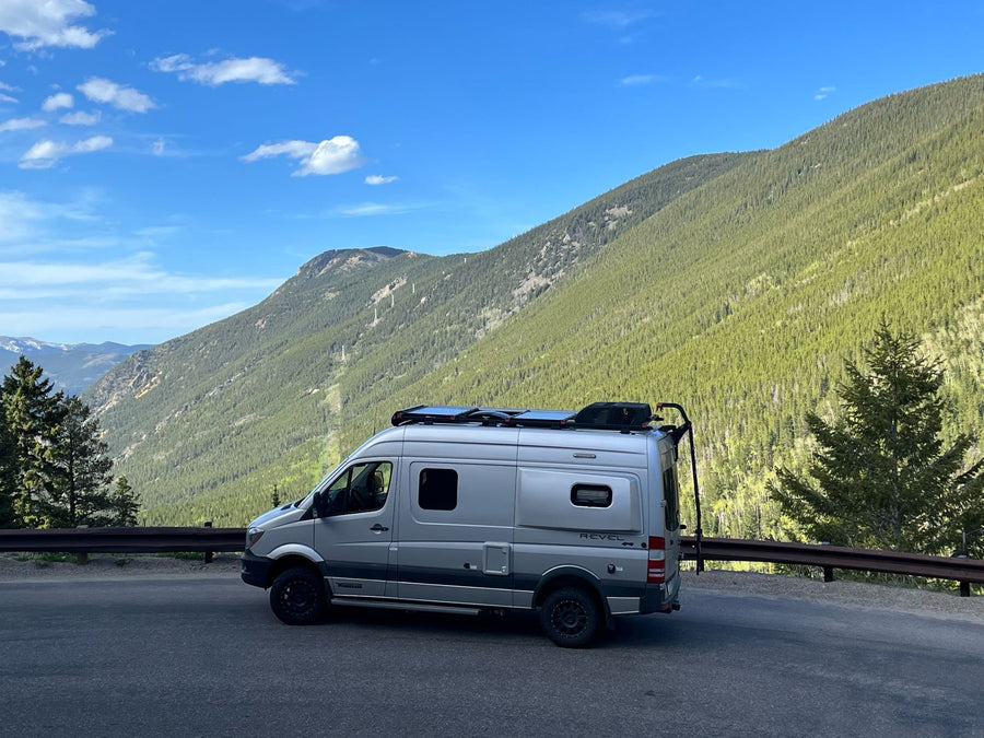 Silver Winnebago Revel 4x4 RV rental on a mountain road