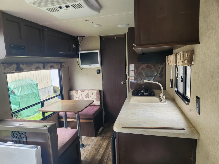 shown with spare tire & cargo rack. Available for RV rental from Campers Inn.|Tan & brown Wolf Pup travel trailer RV