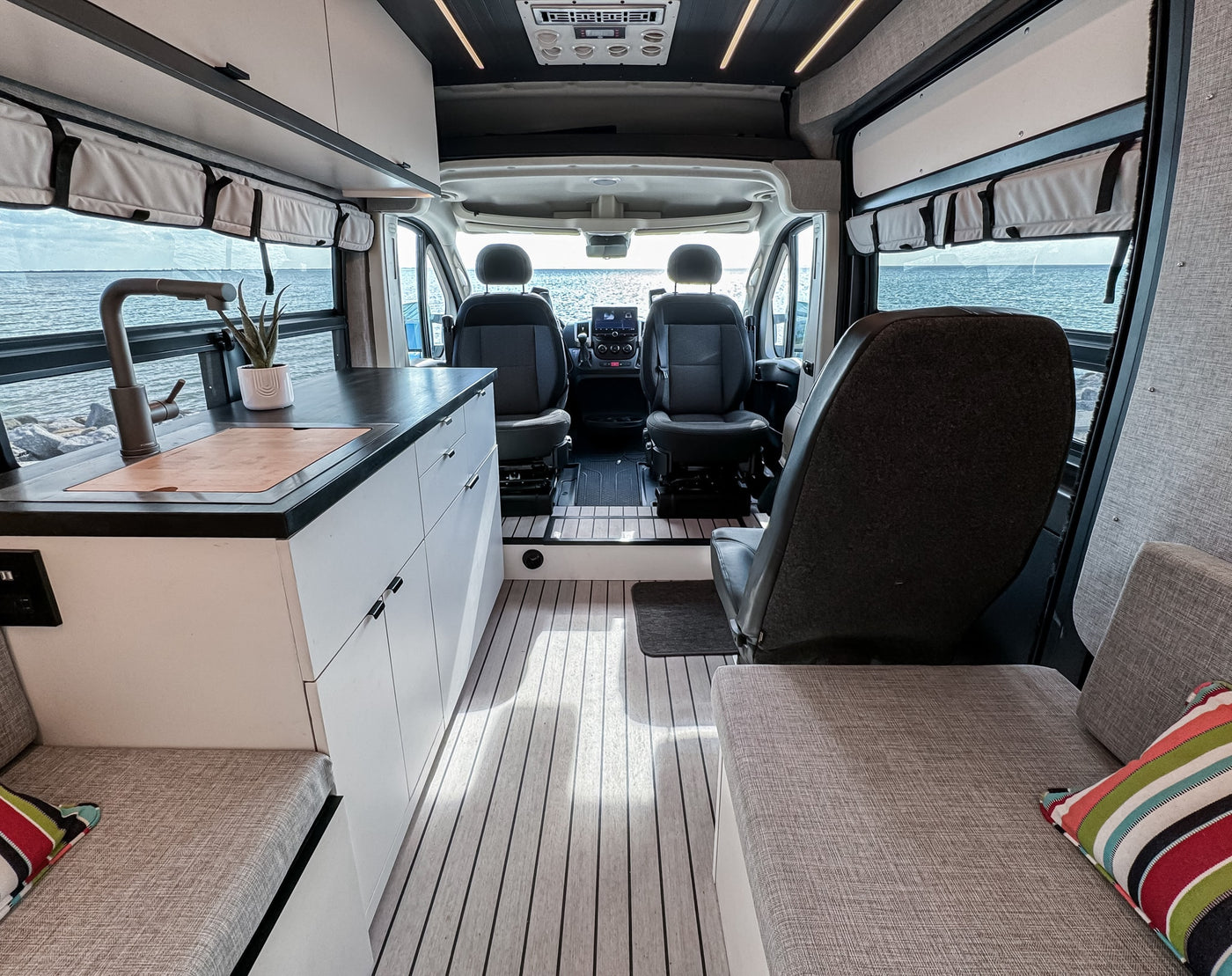 and kitchen setup.|Spacious RV rental interior featuring a bed — photo 6