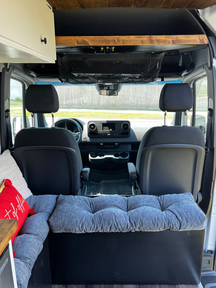 plus a cozy "out of office" living space.|Cozy RV rental interior: Cushioned seating