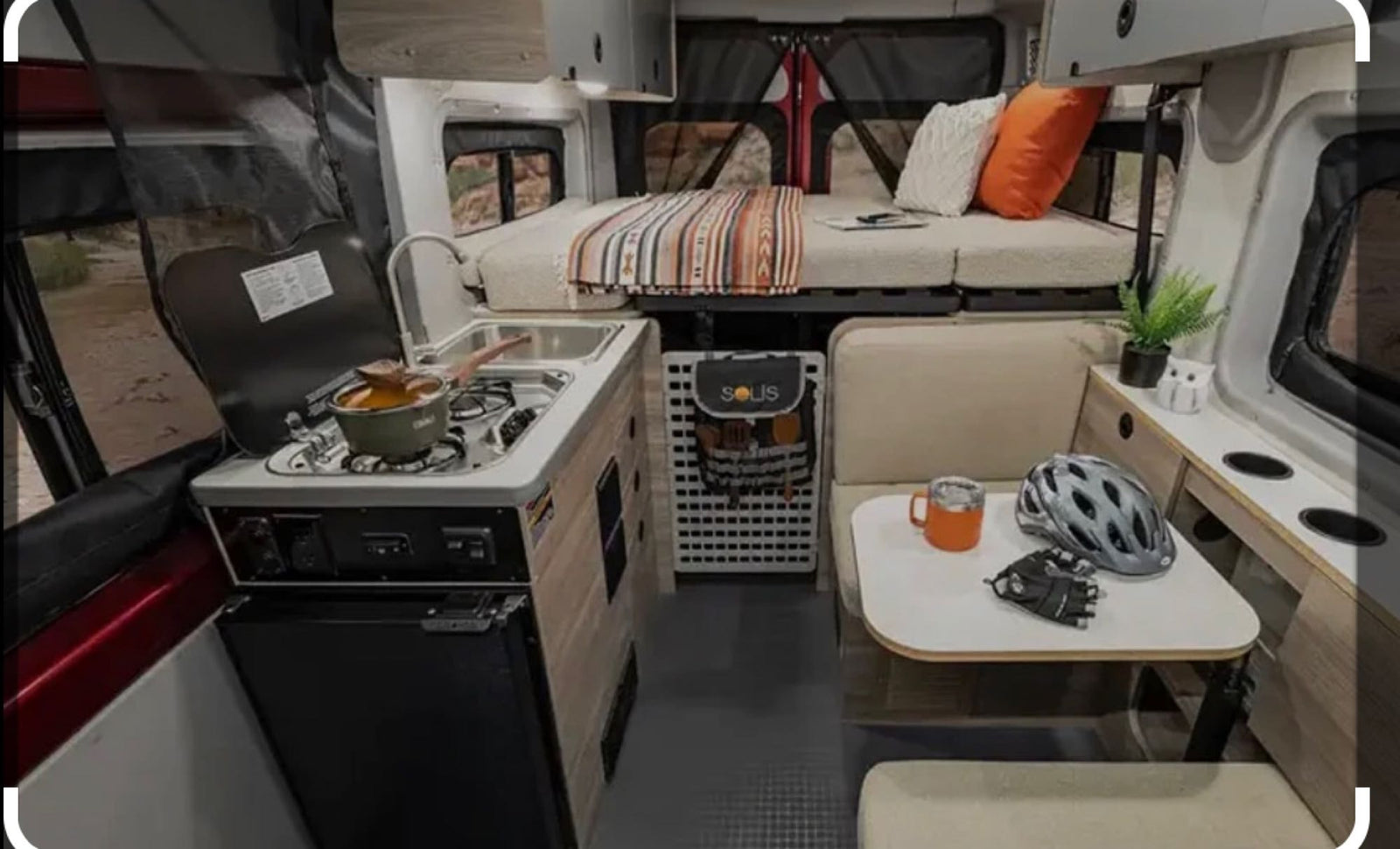 This Solis RV rental offers a compact kitchen, raised bed, and dining area, ideal for mobile living and travel adventures.