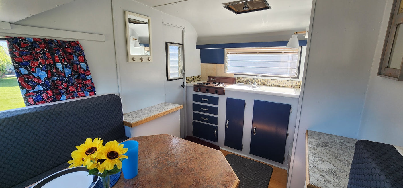 and scenic windows.|RV rental bedroom interior with cozy bed