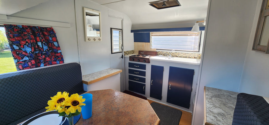 and scenic windows.|RV rental bedroom interior with cozy bed