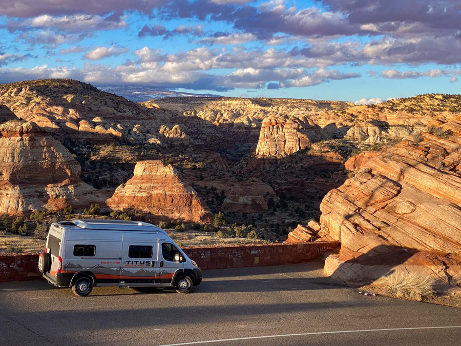 parked at a scenic sunset mountain vista with its door open.|Scenic Titus **rv rental** camper van adventure through red rock canyons