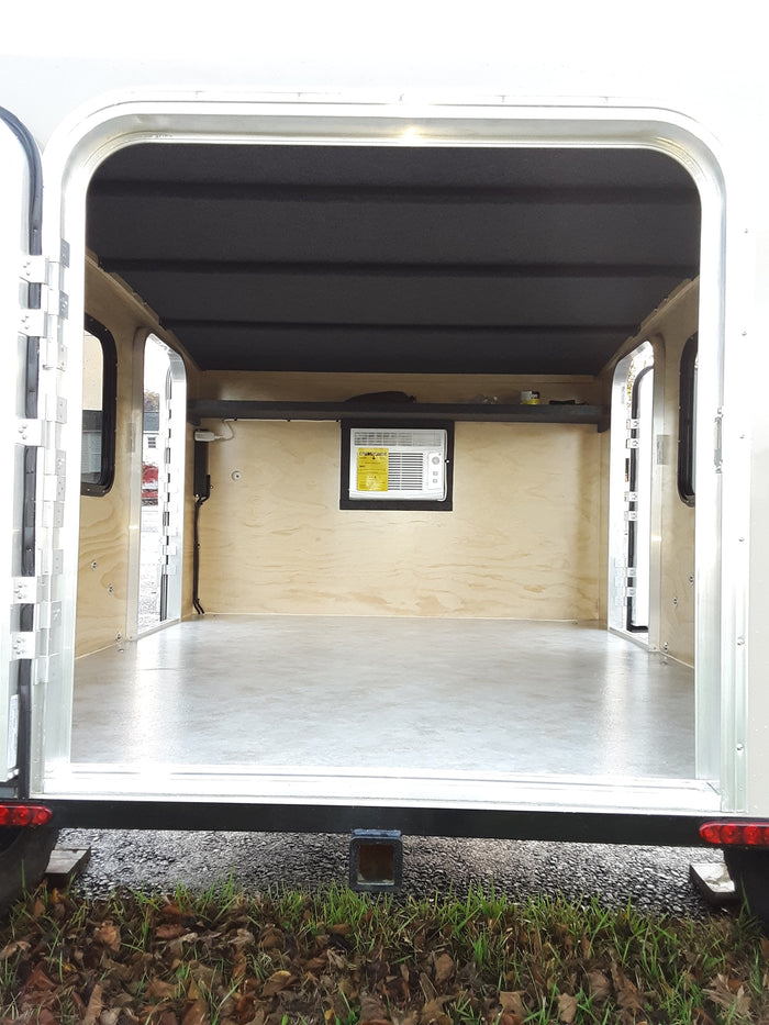 and seating. A small control panel is visible.|RV rental interior showing wall-mounted air conditioner