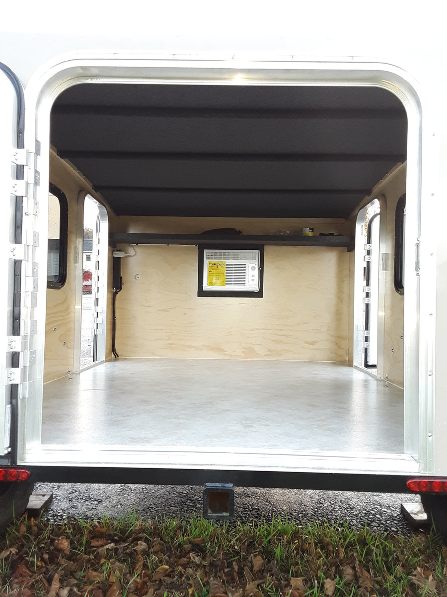 and seating. A small control panel is visible.|RV rental interior showing wall-mounted air conditioner