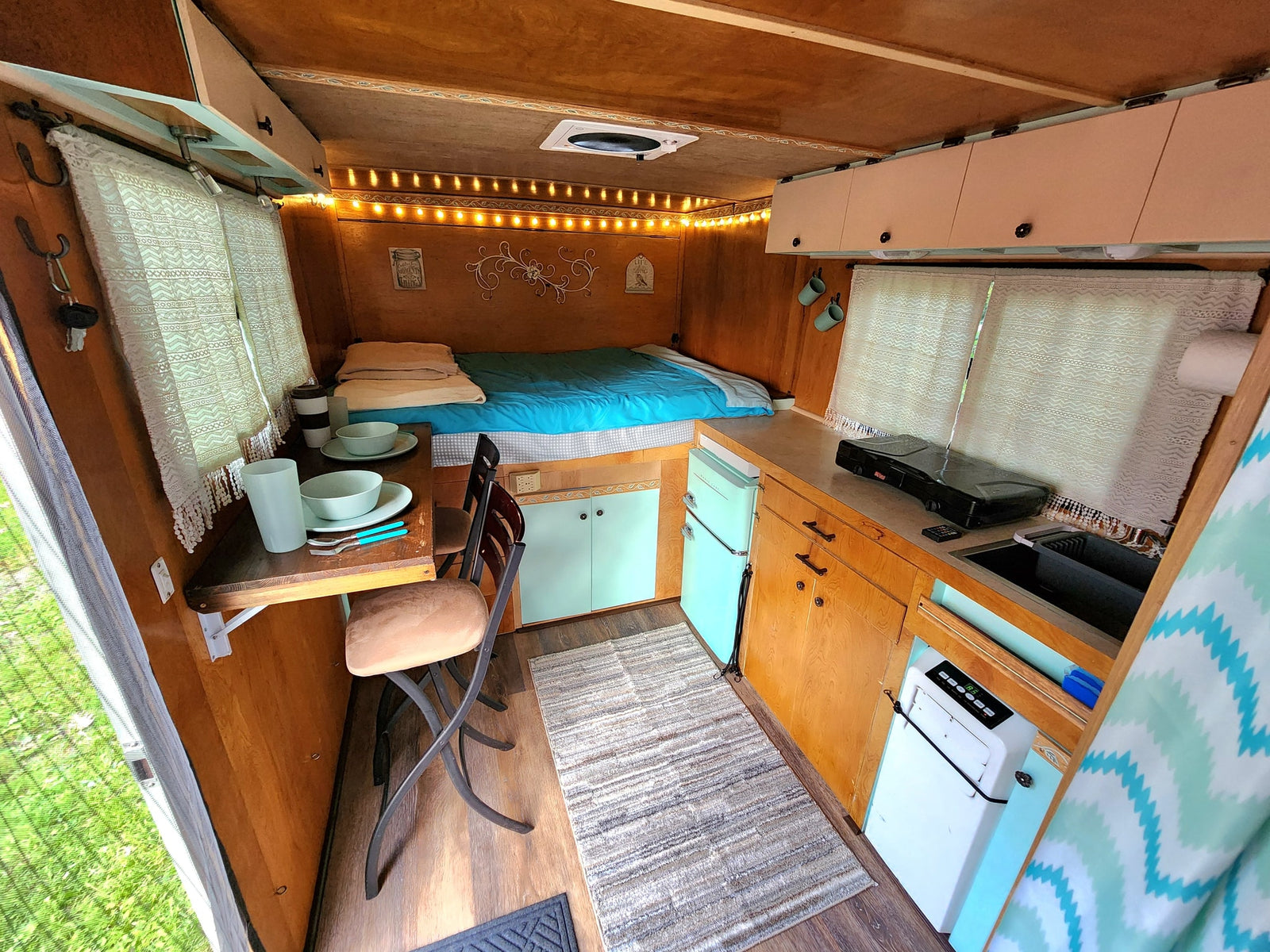 and open back revealing a wooded outdoor scene.|See inside this unique RV rental