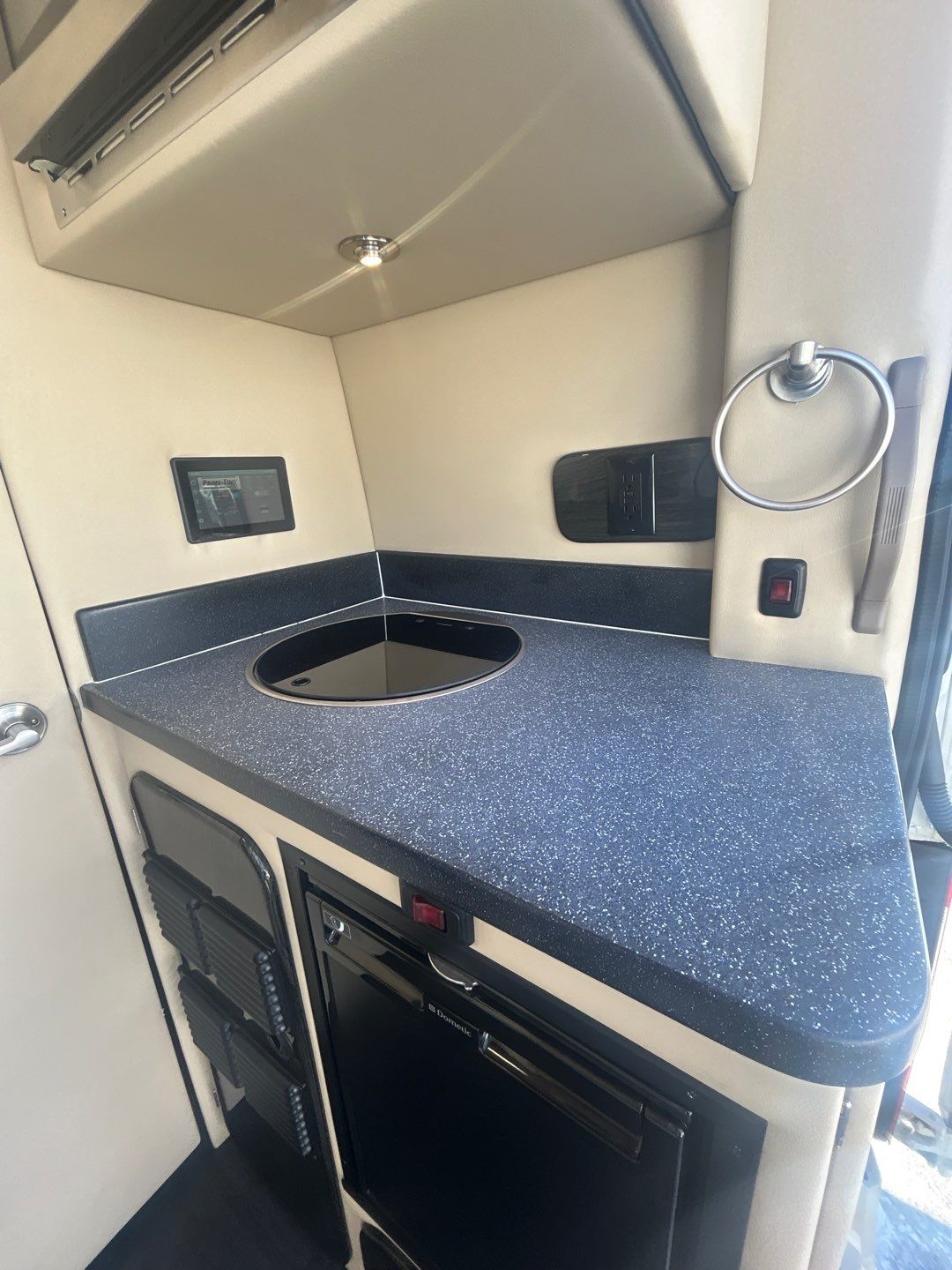 and light walls.|Comfortable RV rental interior with a white quilted bench seat