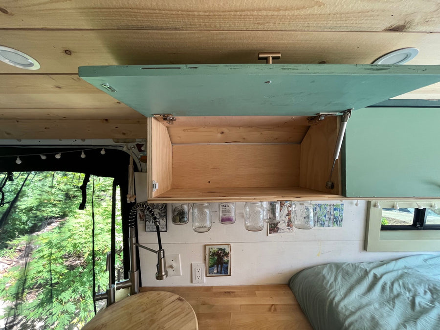 and storage for your next adventure.|RV rental interior: cozy bed