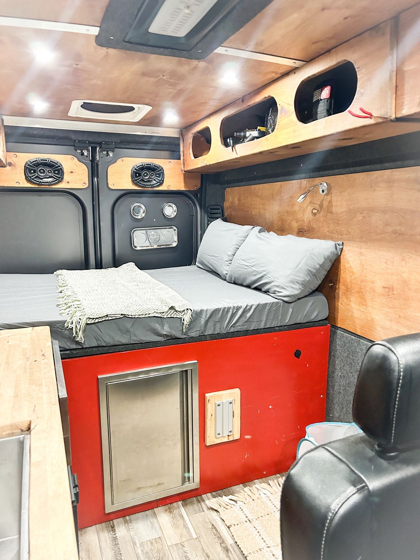 and overhead storage with bags.|RV rental interior: A digital control panel displays "14.0" on wood paneling
