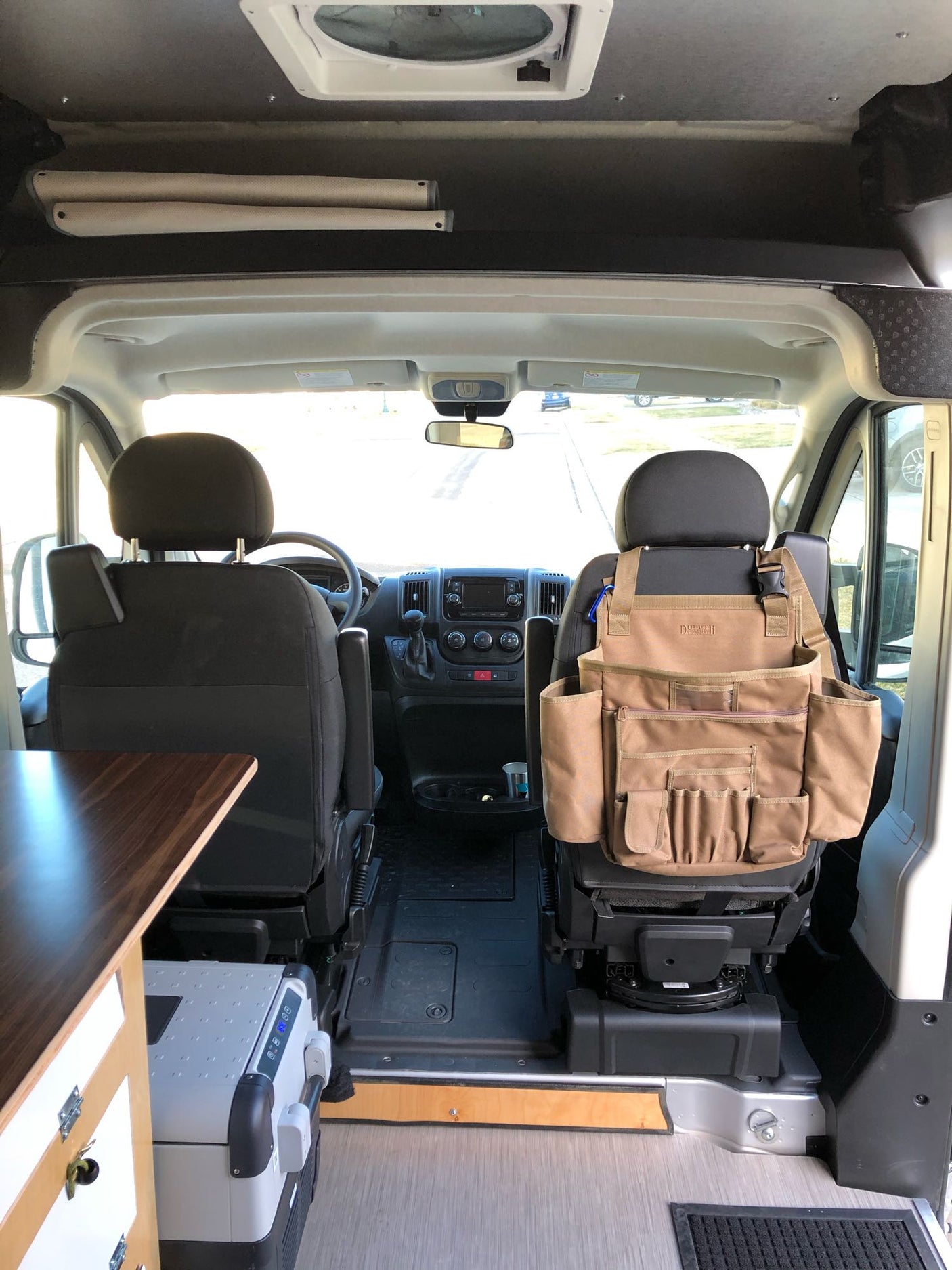 and storage.|Inside an RV rental: a flexible camper van interior with bright green cushions
